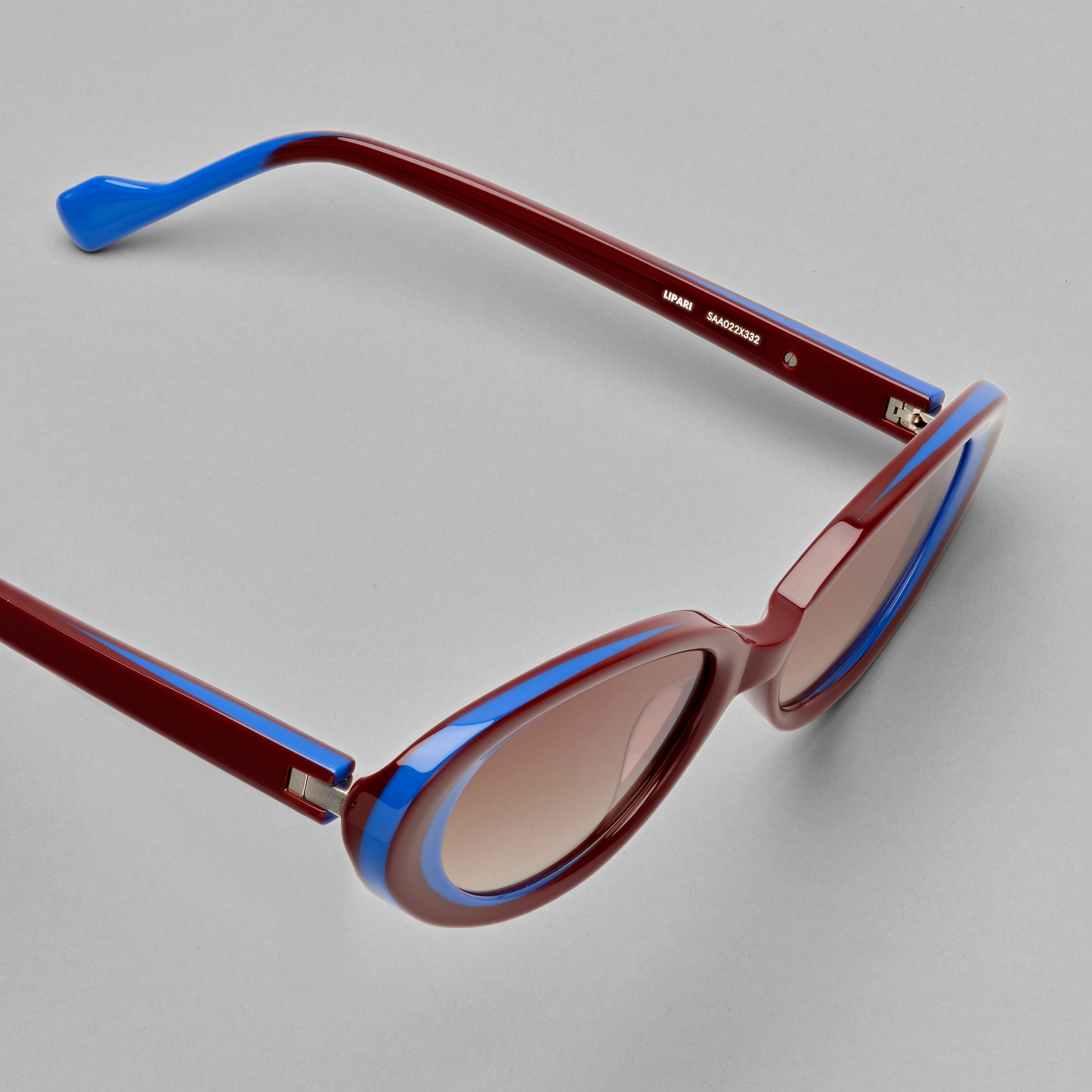Tarian-Lipari-small-oval-cateye-sunglasses-dark-red-blue